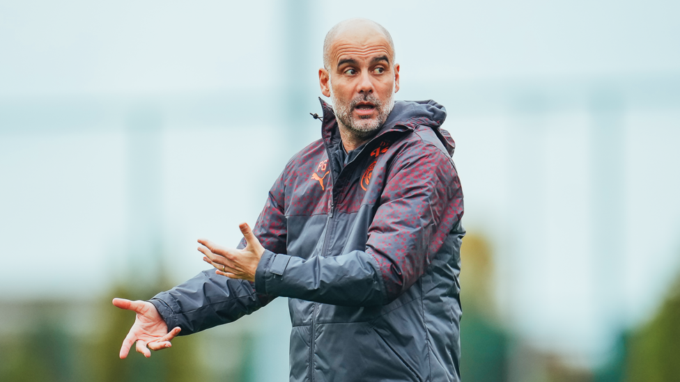 BOSS : Pep Guardiola passes on instructions to his players.