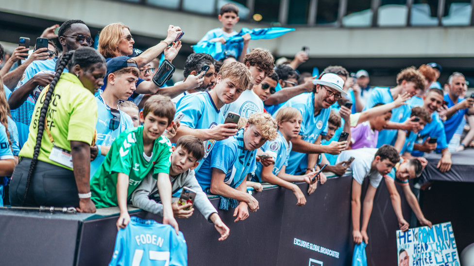 WORLDWIDE BLUES : City fans wait for their heroes to arrive for the pre-match warm up.