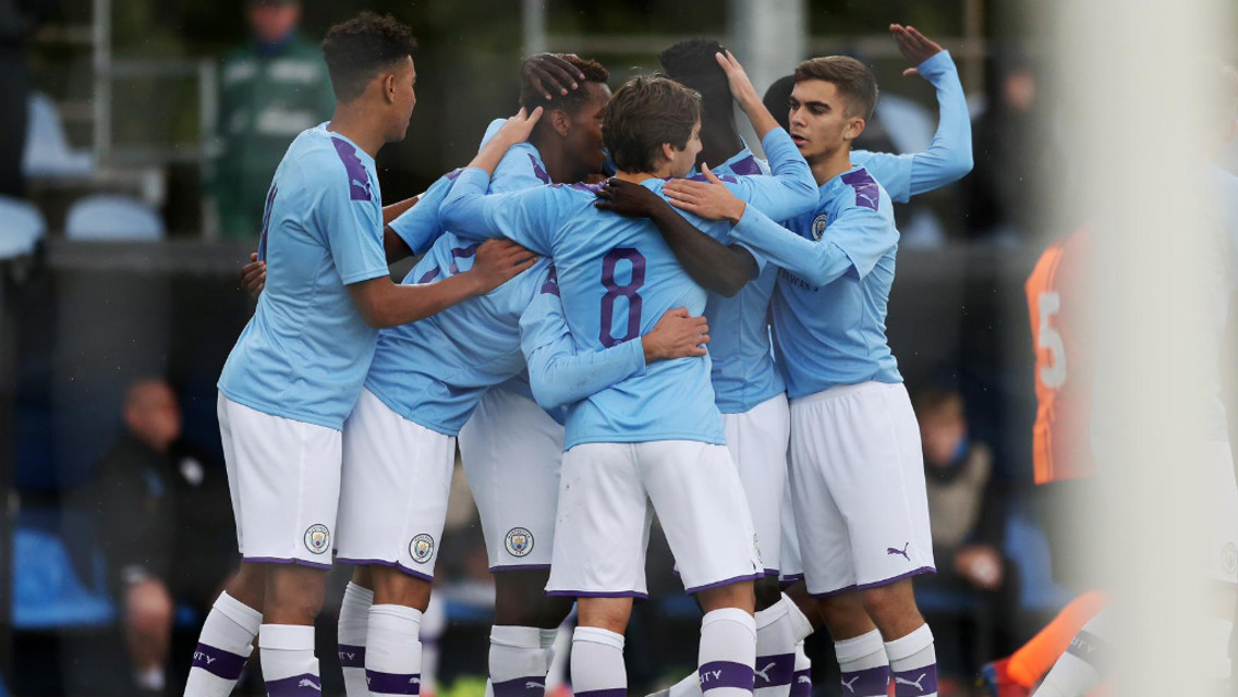 ALL TOGETHER NOW: The team gather to celebrate, as City double the advantage