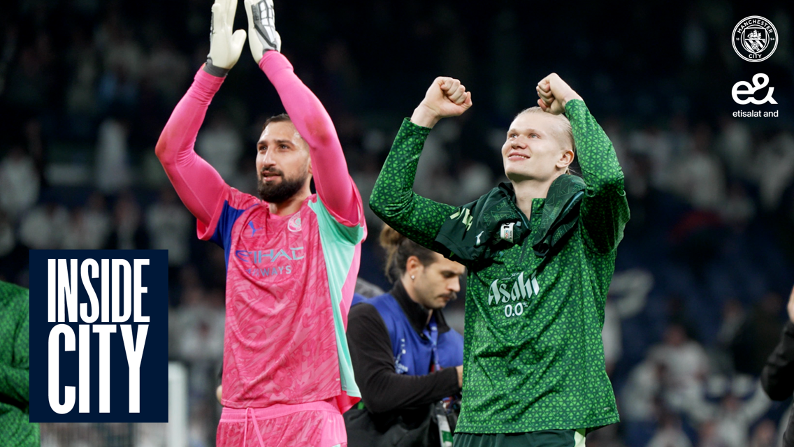 Two Manchester City players celebrate on the pitch, one in pink and the other in a green outfit. The Manchester City logo and Etisalat logo are visible in the top right corner.