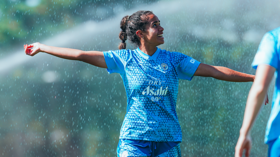 DOWNPOUR : Mary Fowler dodges the sprinklers!