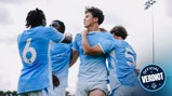 Soccer players in light blue jerseys celebrate a goal together, hugging and holding each other, with 'Official Verdict' graphic in the corner.