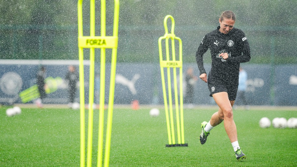 DODGE AND WEAVE : Naomi Layzell tries to avoid the sprinklers.