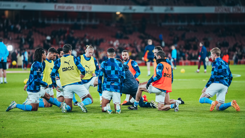 STRETCHING STARTERS : The starting team get loose during the pre-match warm up.