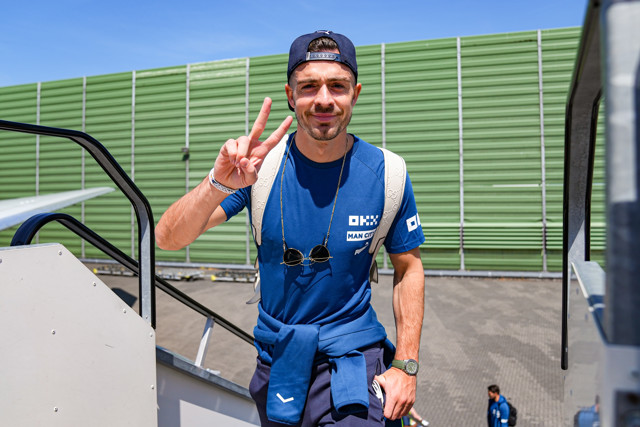 Jack Grealish walking up steps onto the plane 