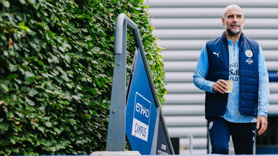 THE BOSS : Pep Guardiola makes his way out for the session