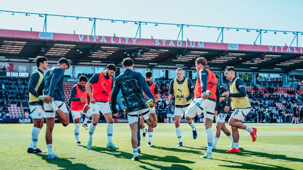 TOGETHER : The starting XI getting warmed up. 