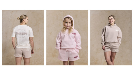 Models displaying Manchester City branded casual wear, including t-shirts and hoodies in neutral tones.