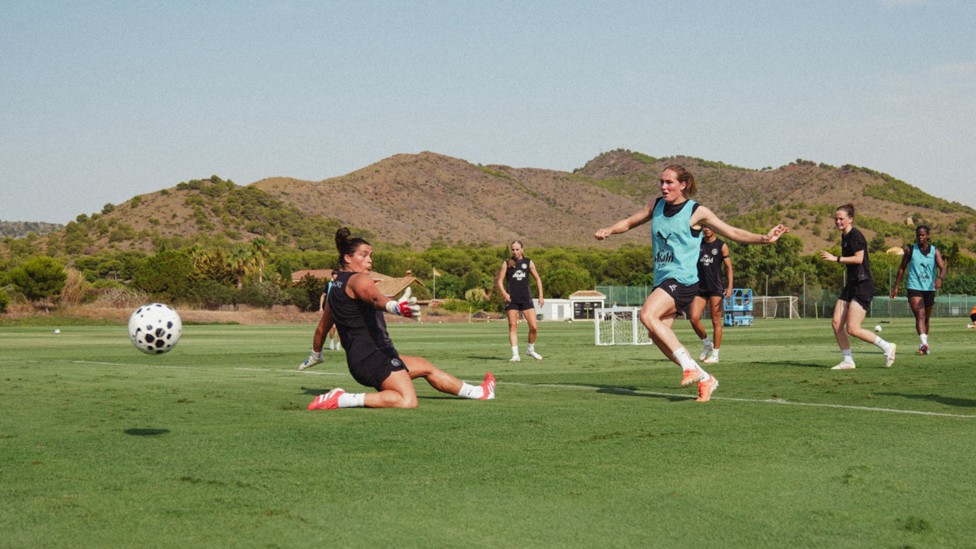 SPAIN GAME: Eartha Cumings and Sydney Lohmann give it their best shot.