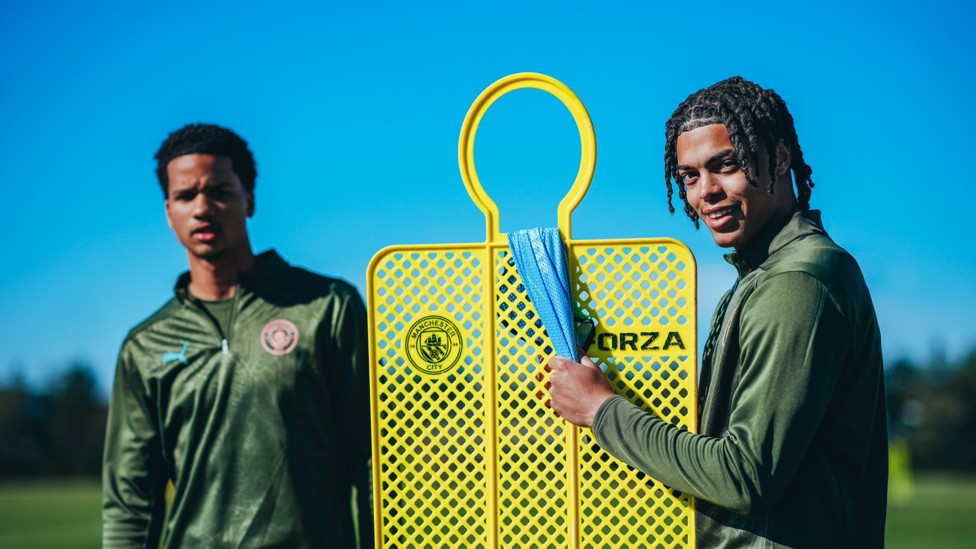 NEW MEMBER: : Divine Mukasa and Jahmai Simpson Pusey pose with a training mannequin
