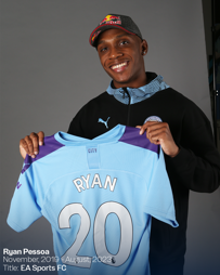 A person wearing a Red Bull cap and Puma apparel is smiling while holding a light blue Manchester City jersey with 'RYAN' and number '20' on it. Text in corner shows 'Ryan Pessoa', dates, and 'EA Sports FC'.