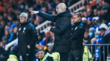 PEP TALK: The boss passes on some instructions from the touchline.