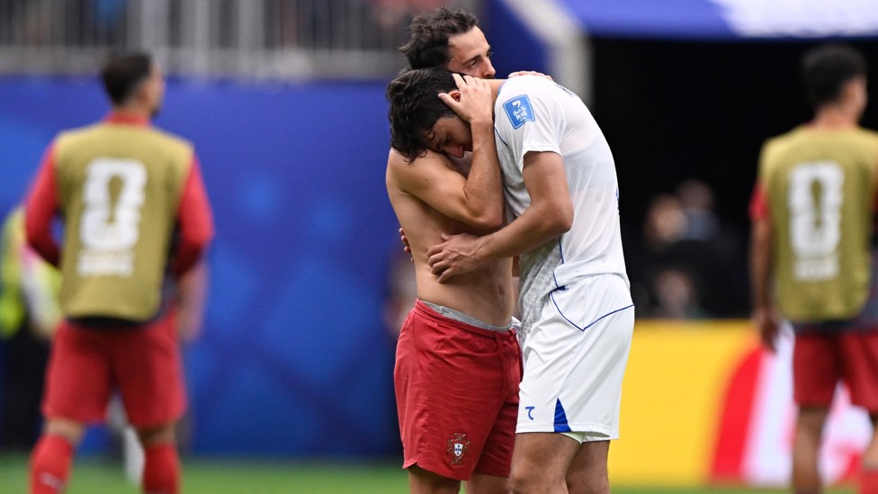  : Abdukodir Khusanov is consoled by former City team-mate Bernardo Silva