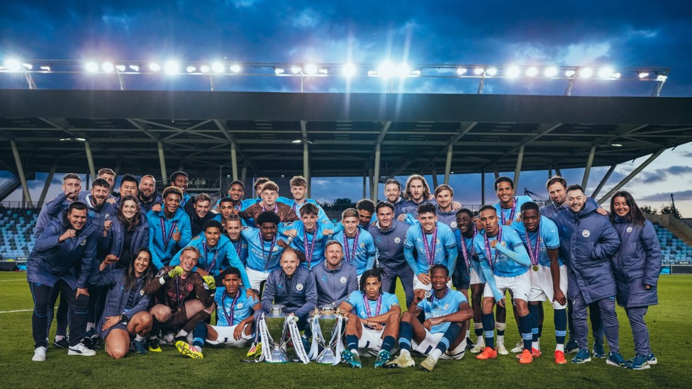 WHAT A TEAM  : The squad and staff celebrate City's fourth PL2 title win.