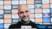 Blurred face of a person speaking at a press conference with a background featuring sponsorship logos including Puma and Etihad.
