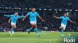 Players in Manchester City jerseys celebrating a goal on the soccer field during a UEFA Champions League match. Text reads 'Thank you Rodri'.