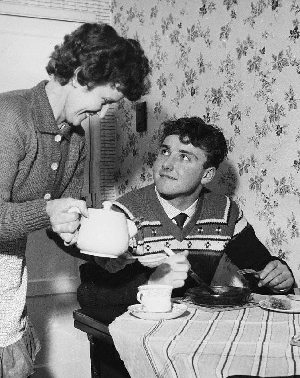 MOTHER'S PRIDE: A 15-year-old Glyn Pardoe gets a cup of tea from his Mum the morning after his City debut