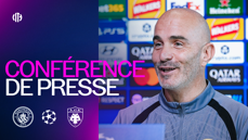 A press conference image featuring Manchester City and AEK Athens logos, highlighting a UEFA Champions League event. The backdrop shows various sponsor logos.
