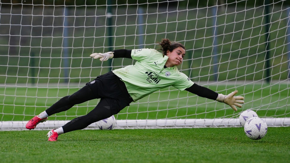 GREAT SAVE : Eartha Cumings gets low to deny the goal. 