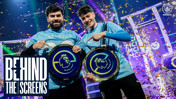 Two esports players hold Manchester City ePremier League championship plaques amidst confetti. The event is titled 'Behind the Screens' and features the Manchester City Esports logo.