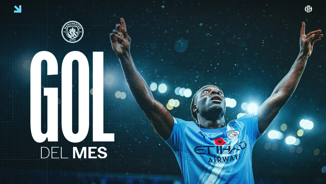 Manchester City's 'Goal of the Month' image features a player in the Manchester City kit celebrating a goal. The player's face is blurred, and he is lifting his arms in celebration. The background displays bright stadium lights.