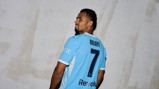 A soccer player wearing a light blue jersey with the name 'NDIAYE' and number 7 on the back looks over his shoulder.