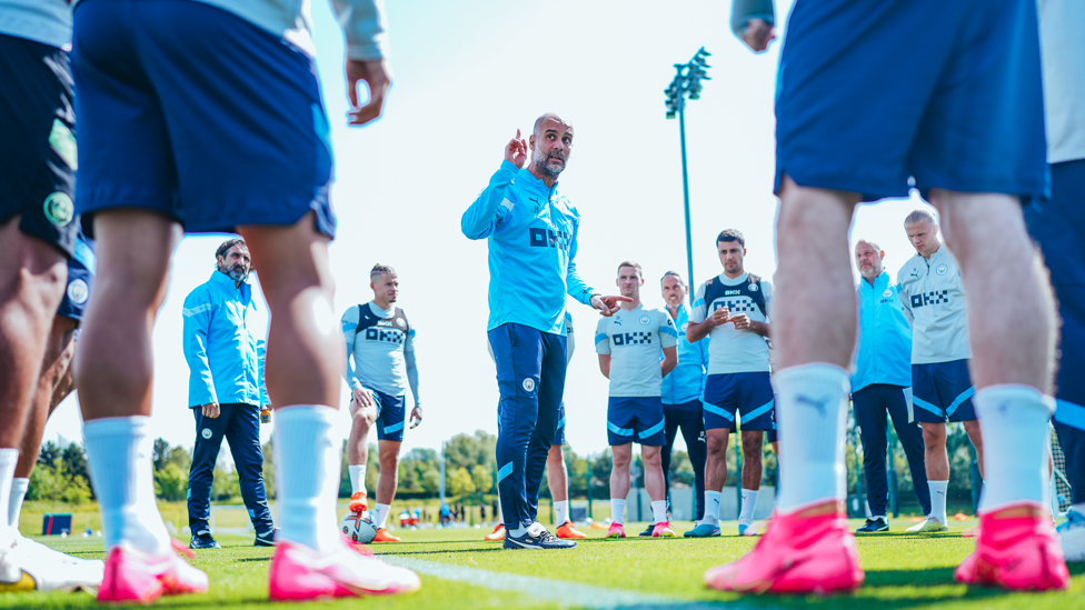TEAM TALK : Pep Guardiola surrounded by his players. 