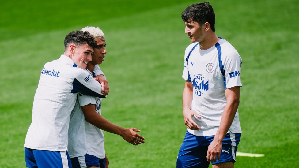 FIRM FRIENDS : Rico Lewis gets a hug from Phil Foden