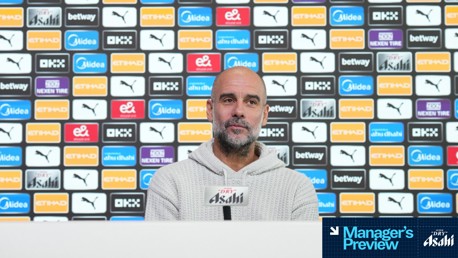 A person is speaking at a press conference with a backdrop featuring various sponsor logos including Puma, Etihad, and Asahi. The text 'Manager's Preview' is visible at the bottom right.