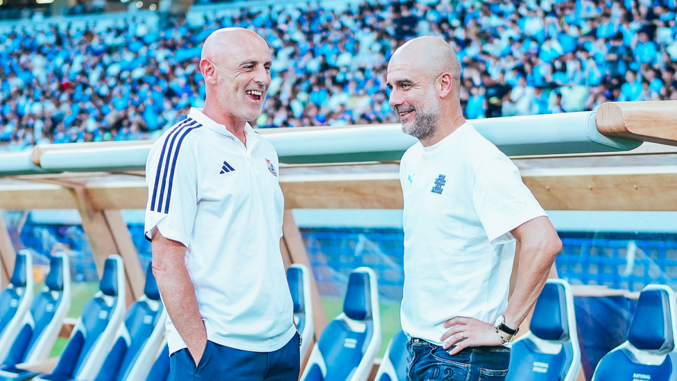 PEP TALK : Yokohama boss Kevin Muscat chats with Guardiola before kick-off