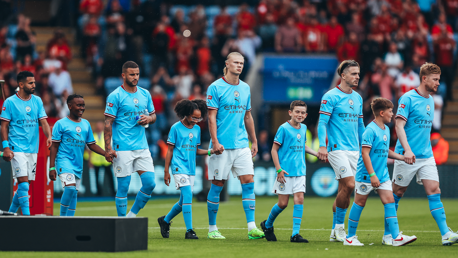 SQUAD GOALS: City's starters make their way onto the pitch.