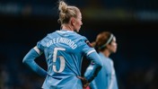 A football player wearing a Manchester City uniform with the name 'Greenwood' and number 5 on the back.