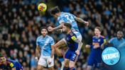 Soccer players in action with one jumping to head the ball. 'Official Verdict' badge in bottom right.