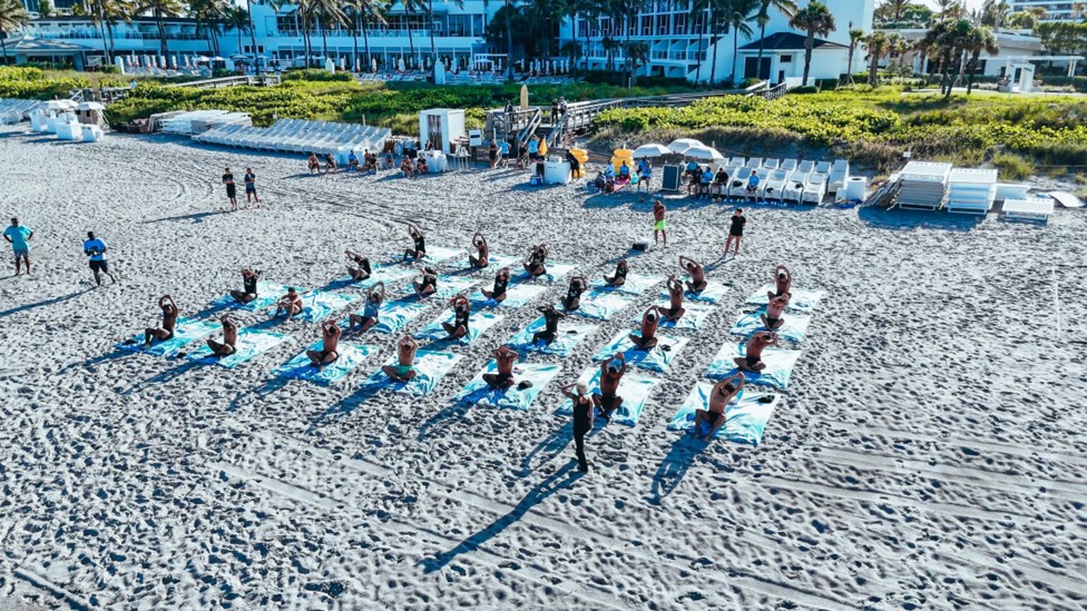 ALL TOGETHER NOW: An amazing drone shot captures the players during their beach yoga session.