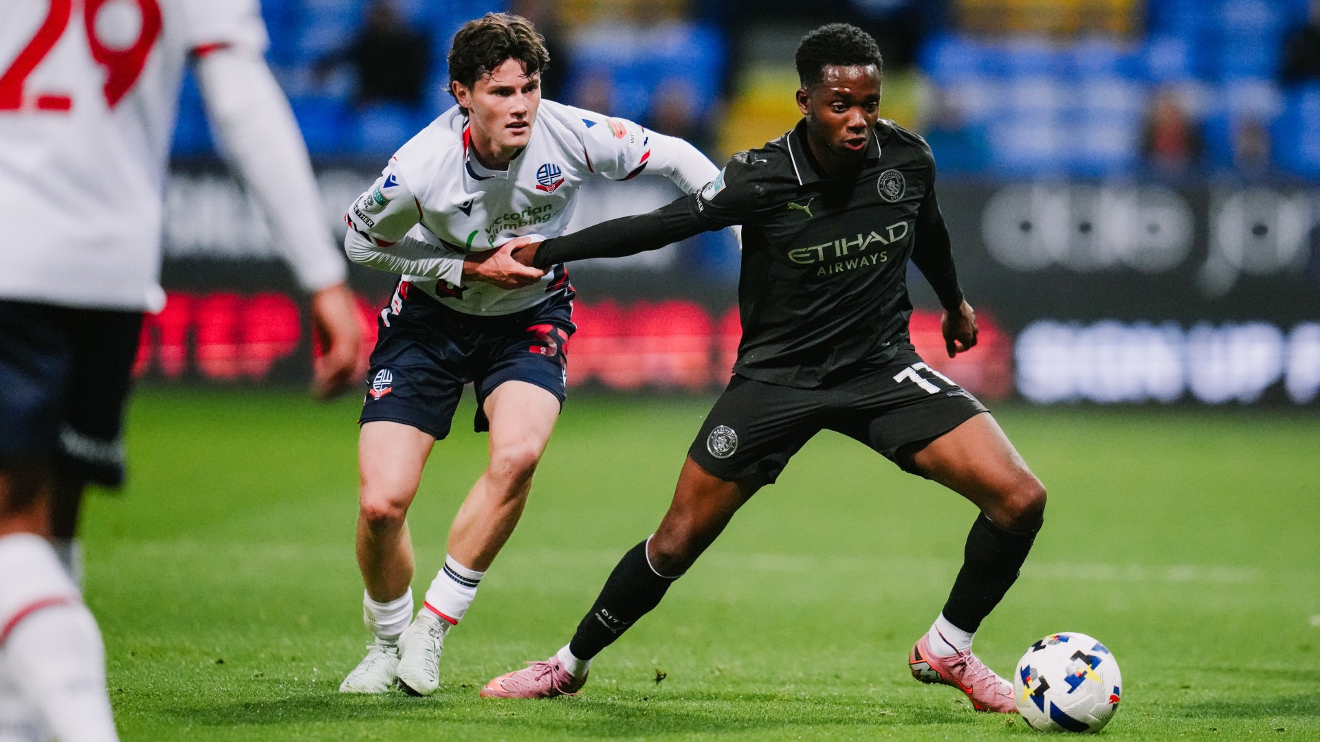 CLOSE QUARTERS: Justin Oboavwodou looks to break free of the Bolton shackles.