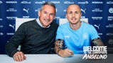 HE'S BACK: Putting pen to paper to seal his return!