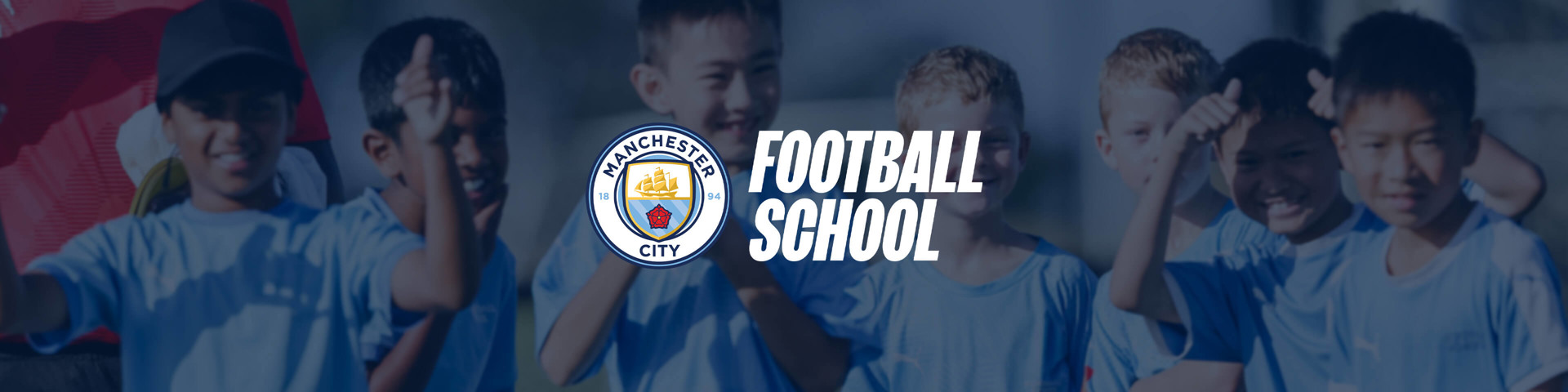 A group of children wearing Manchester City football kits with blurred faces, with the Manchester City Football School logo overlaid on the image.