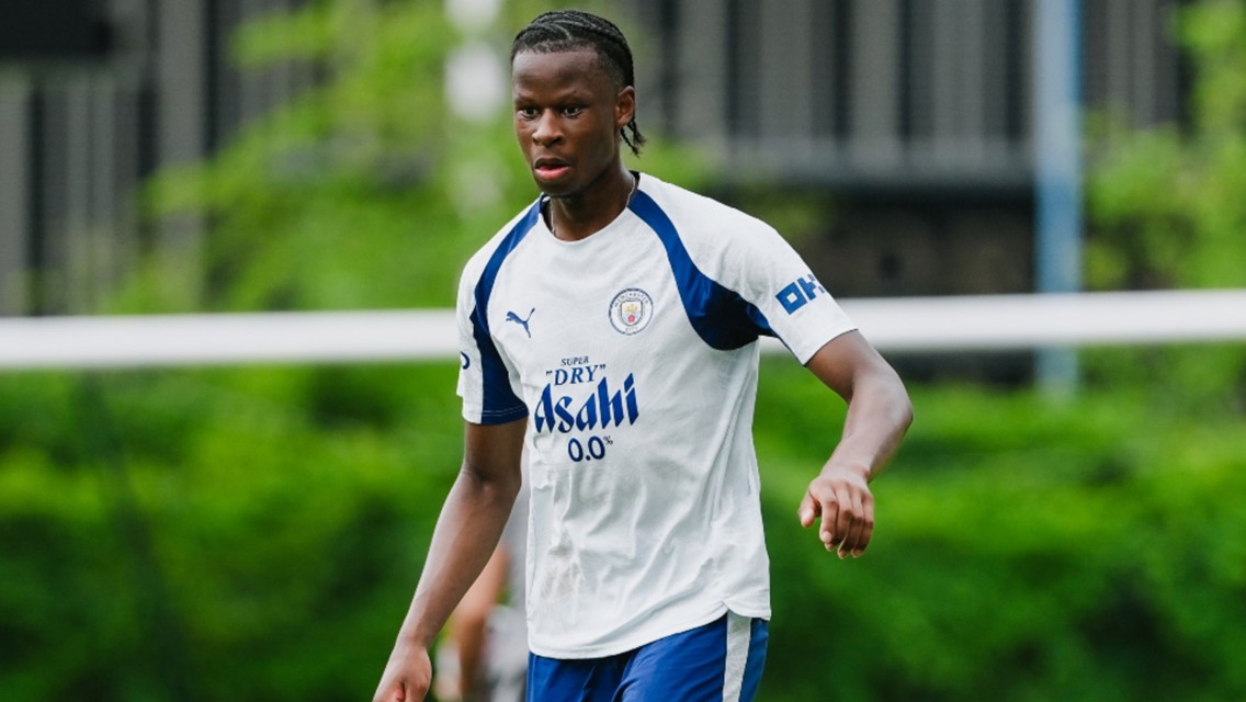 A soccer player wearing a Manchester City training jersey during practice.