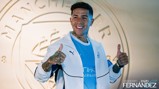 Person in a Manchester City jacket giving two thumbs up. Background features Manchester City crest and text 'Welcome to City Enzo Fernandez'.