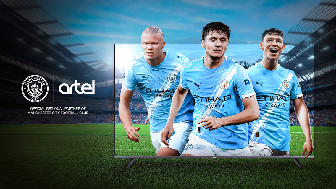Advertisement featuring Manchester City players on a screen with the Manchester City logo and the text 'Official Regional Partner of Manchester City Football Club.'