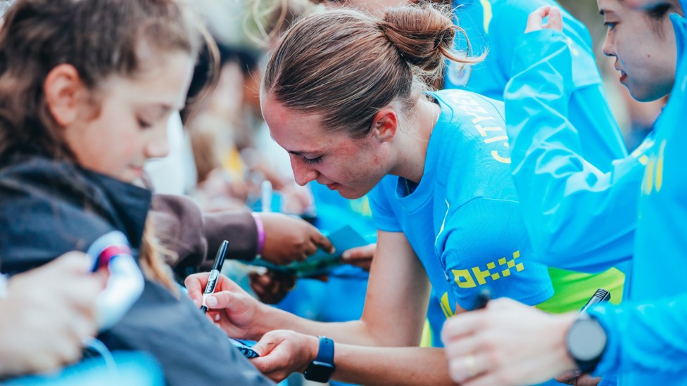 AUTOGRAPH ALLEY : The players make their way down the line