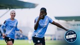 Manchester City Women players celebrating a goal on the field, wearing Manchester City blue kits, with a blurred logo 'Official Verdict' visible.