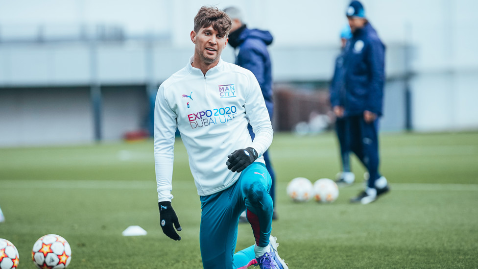 KNEES UP: John Stretches stretches and flexes during Tuesday's session