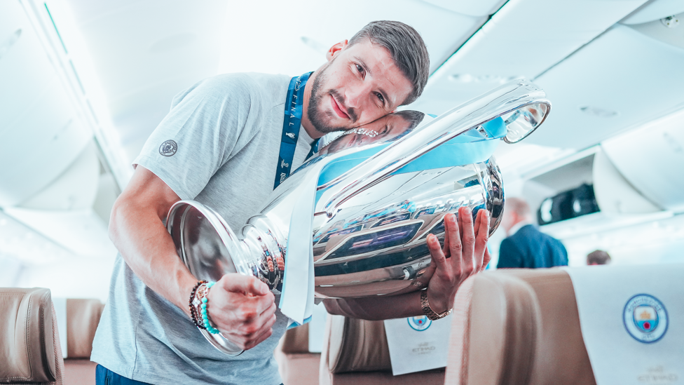 HEADREST : Ruben Dias looks comfortable with the trophy in his arms.