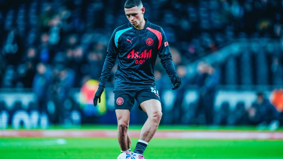PHIL-ING GOOD : Foden gets in the mood during the pre-match warm up.