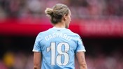 Manchester City player wearing a blue jersey with 'CASPARIJ' and number 18 on the back, during a match.
