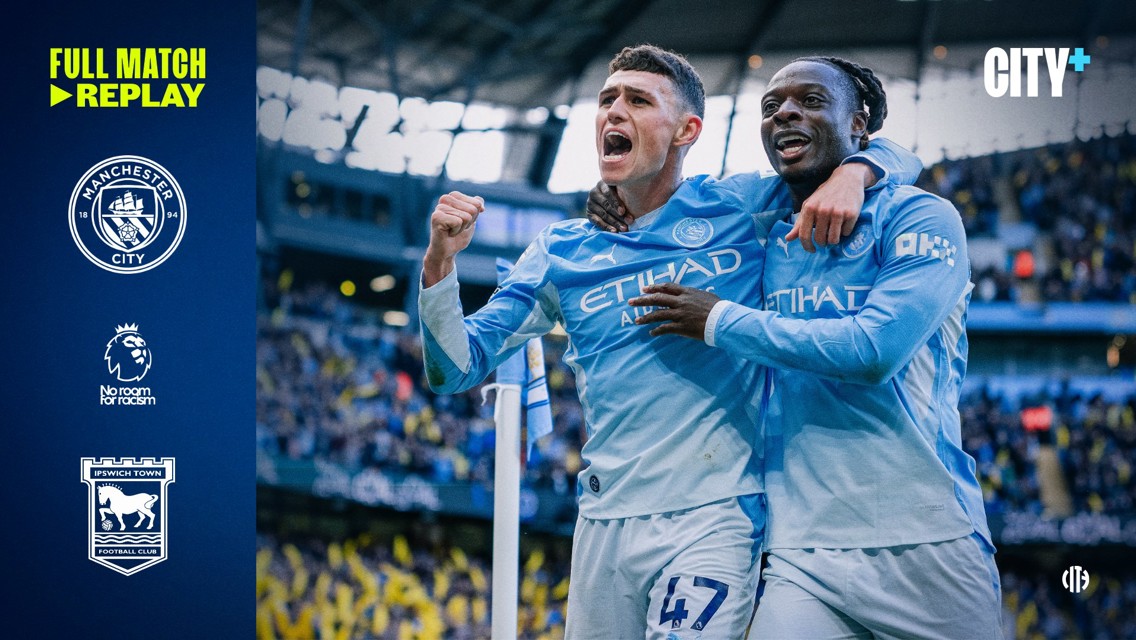 Two Manchester City players celebrating during a match at Etihad Stadium. The left side shows logos and text promoting a match replay against Ipswich Town.