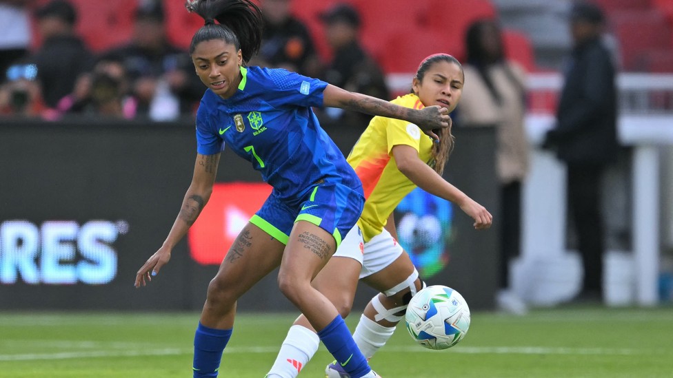 BATTLING IT OUT:  Kerolin and Colombia's Leicy Santos fight for the ball 