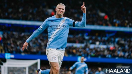 A football player in a Manchester City jersey celebrates a goal with a raised finger gesture. The text '200 appearances' and 'Haaland' are visible.