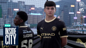 Two men in Manchester City jerseys stand outdoors with a cityscape in the background, marked with 'Inside City.'